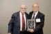 Dr. Nagib Callaos, General Chair, giving Dr. Mario Lamanna a plaque "In Appreciation for Delivering a Great Keynote Address at a Plenary Session."